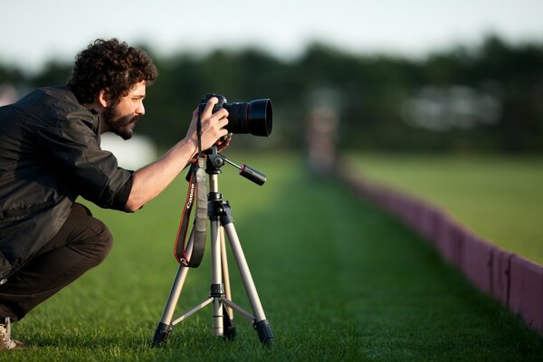 A man with a beard is taking pictures of something