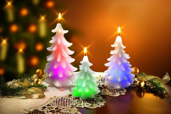 Festive candles on the table. Candles in the shape of a Christmas tree