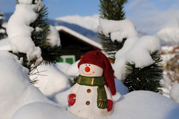 Christmas toy snowman in a snowdrift