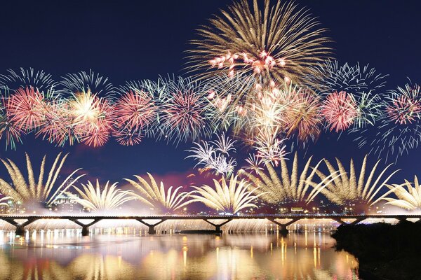 Colorful explosions of fireworks over the bridge