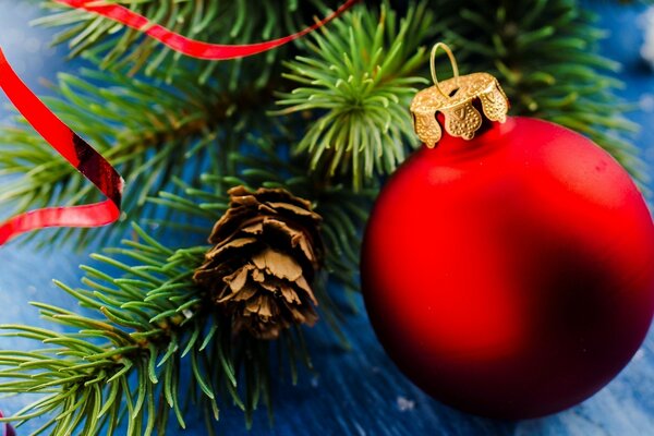 A red glass ball on a green spruce branch