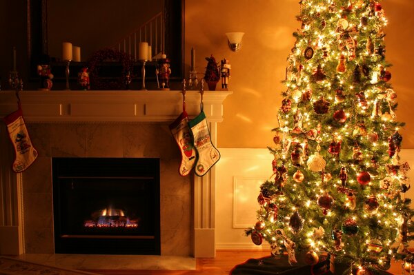 A room with a fireplace and a Christmas tree