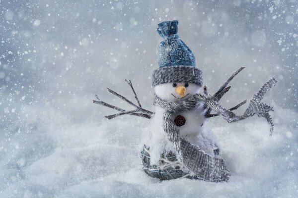 Pupazzo di neve giocattolo sullo sfondo della neve