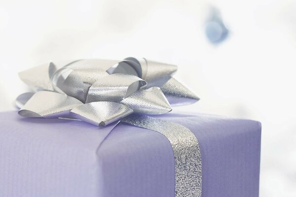 Purple gift box tied with a silver ribbon