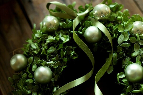 Green balloons with ribbons on a New Year s wreath