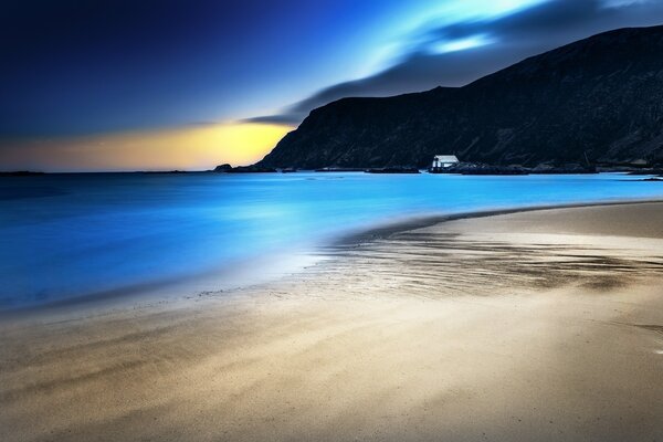 Playa nocturna y grandes montañas