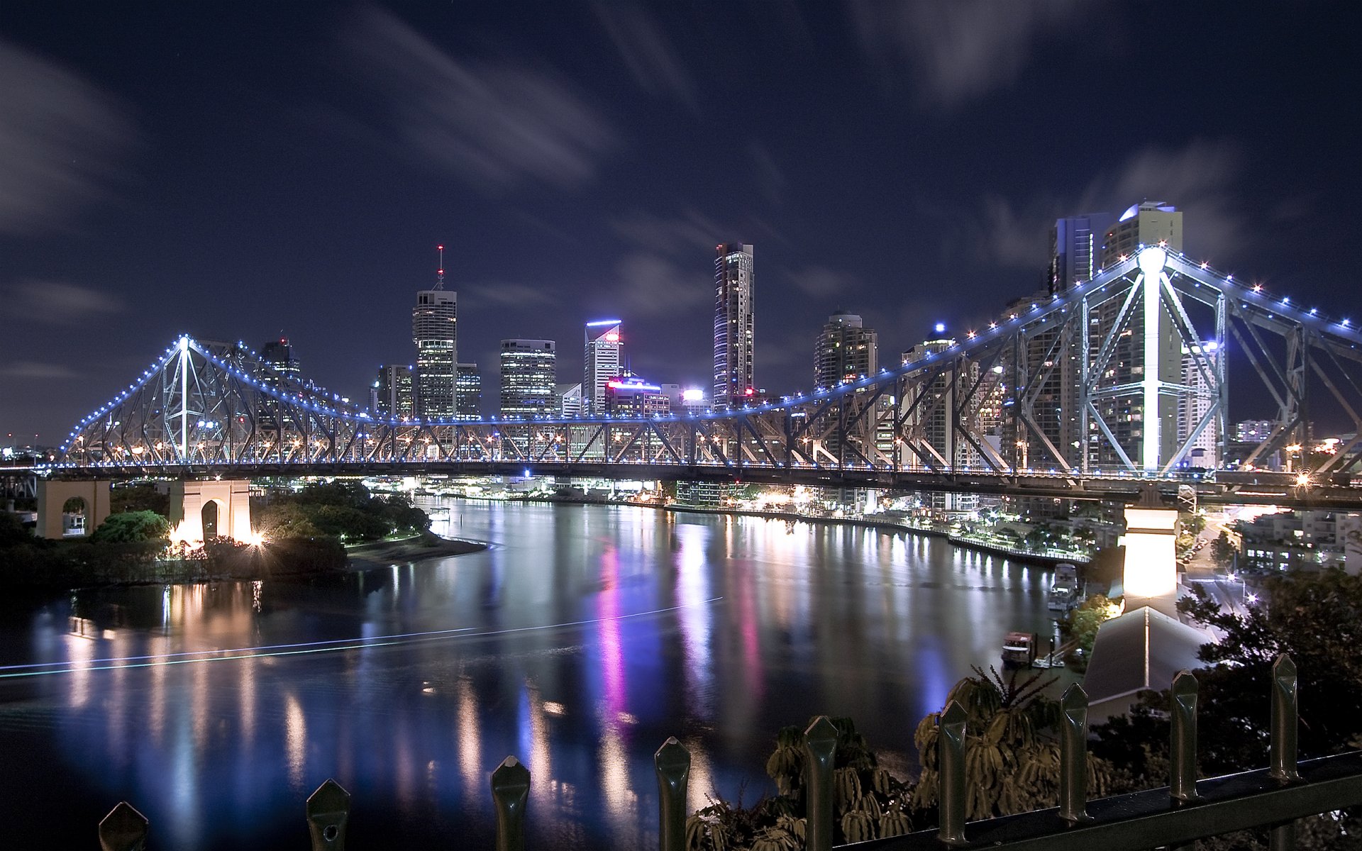 bridge river night city lights house skyscraper