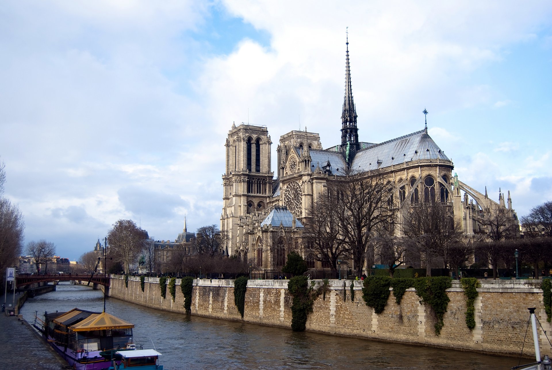 notre dame paris france notre dame de paris river bridge boat clouds sky