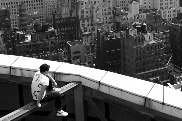 Vista de la ciudad desde lo alto. Foto del chico de atrás. Chico en el techo