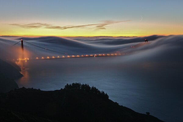 Paesaggio nebbioso con ponte sul fiume