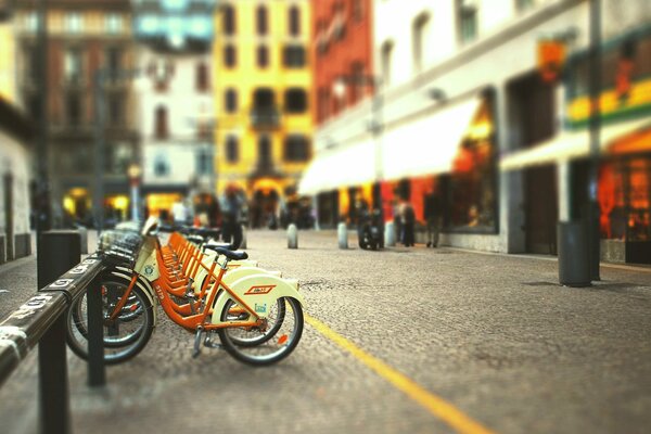 A road with parked bicycles among residential buildings