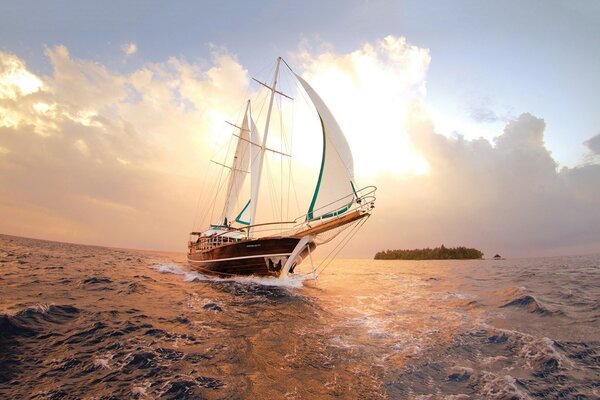 Beautiful yacht on the background of the sea and clouds