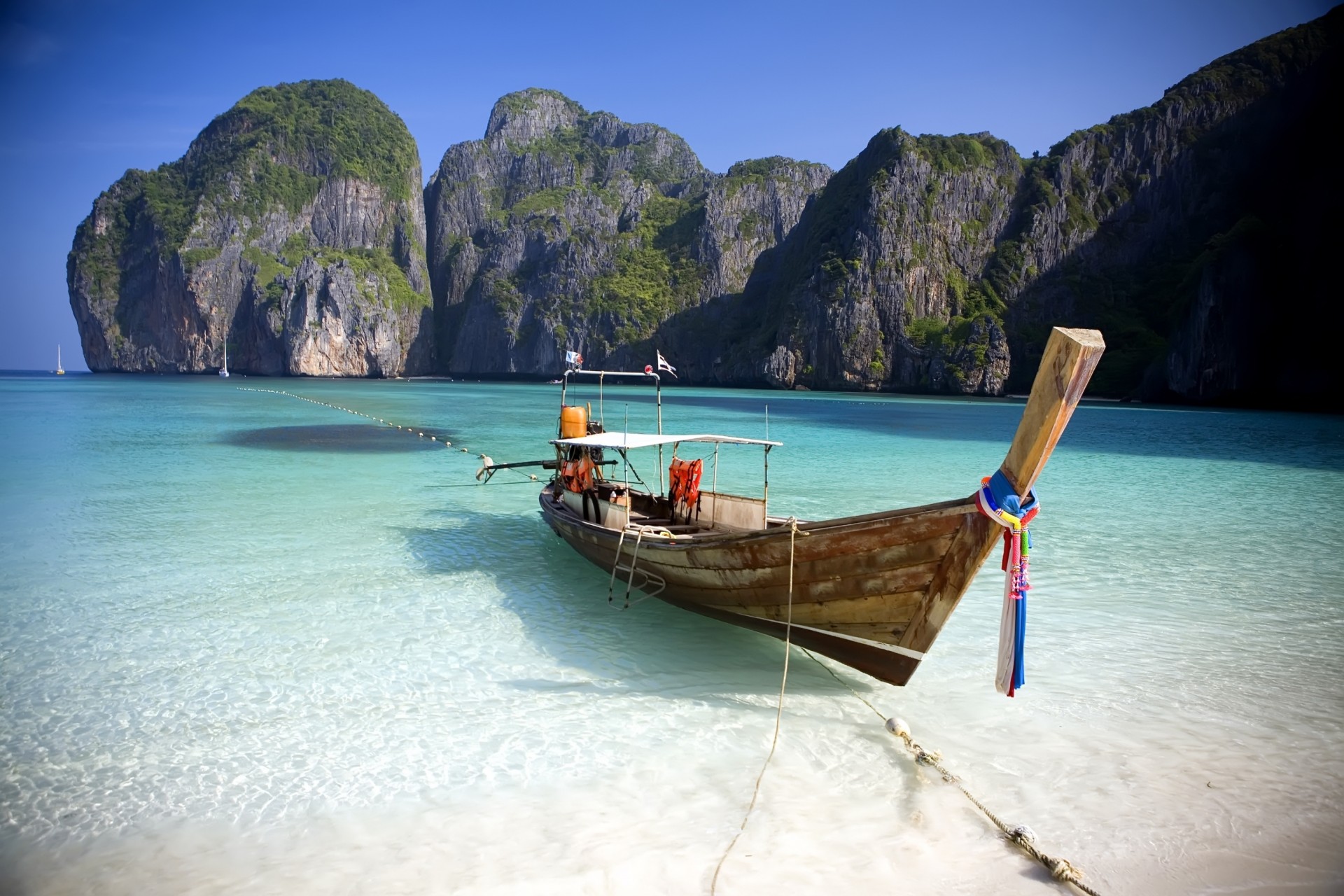 beach blue ocean island shore water rocks boat