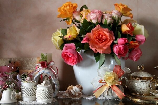 A bouquet of flowers and porcelain dishes are on the table