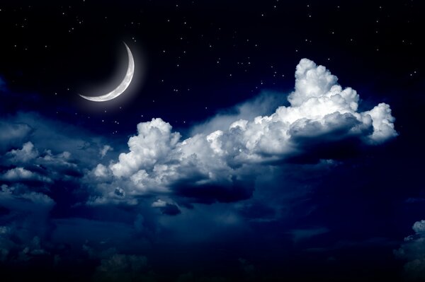 The sky is full of night clouds and the moon is shining