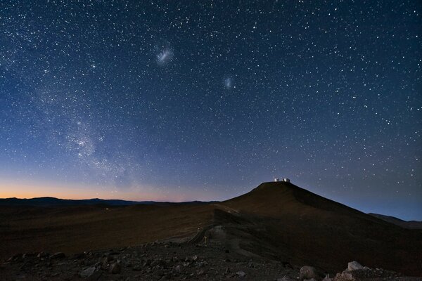 Cielo estrellado sobre una montaña en el desierto en la noche