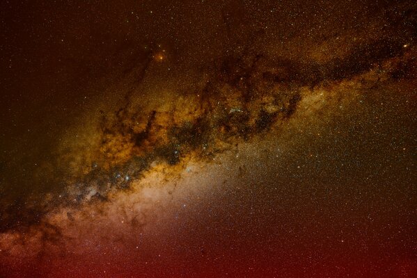 The Milky Way stretches endlessly in red tones