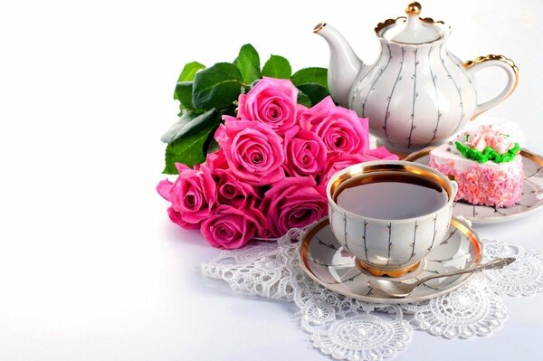 Tea in a cup on a background of pink flowers and dessert