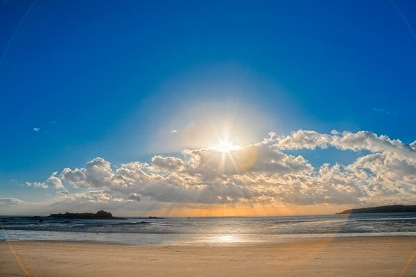 The beach by the sea and the blue sky