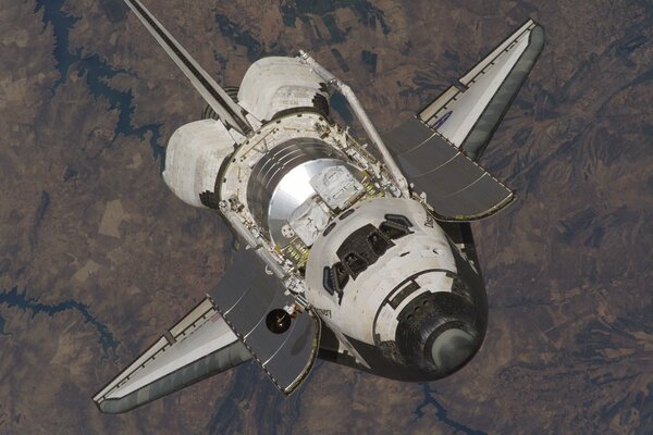 Shuttle discovery in space against the background of the earth