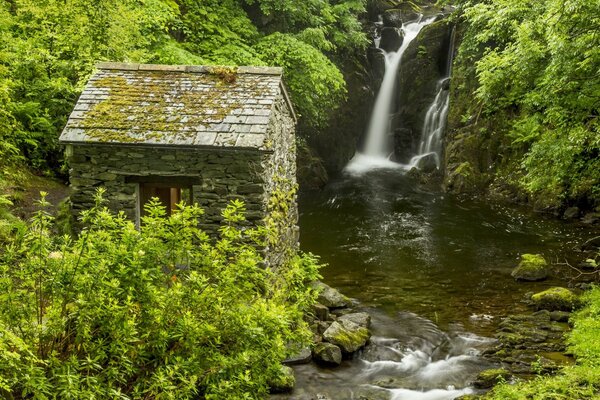 Stone hut next to the waterfall