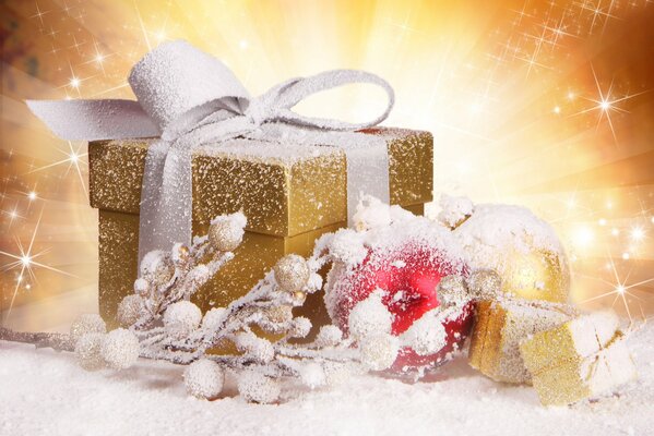 Golden gift box with a snow branch