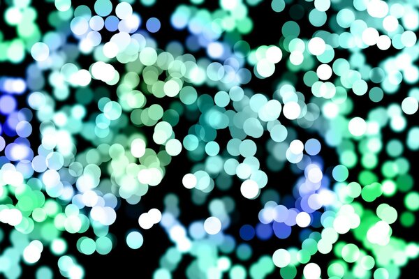 Bokeh effect blue and green colors on a black background