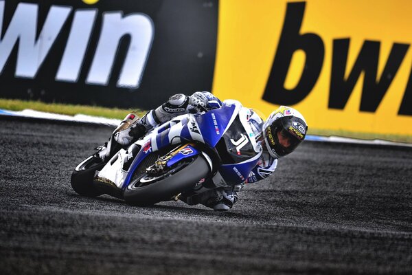 A sharp turn of a motorcyclist at speed