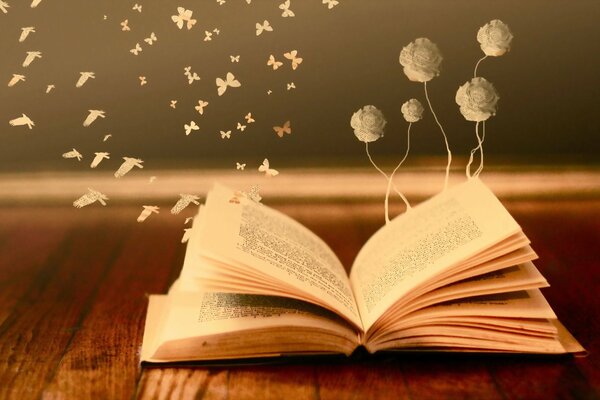 Fleurs et papillons flottant sur un livre ouvert