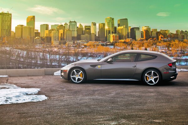 Grey Ferari on the background of the city