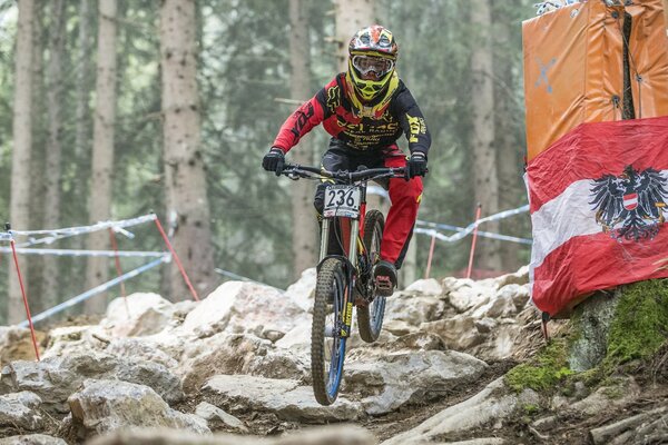 A cyclist in a helmet participates in a race and rides off-road