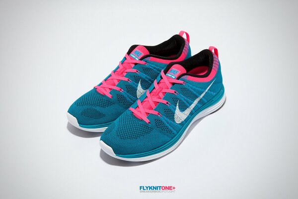 Nike sneakers are blue with pink laces