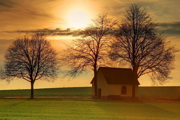 A lonely house in the middle of an autumn field