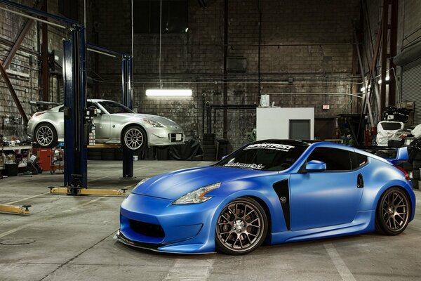 A blue tuned nissan is in the garage