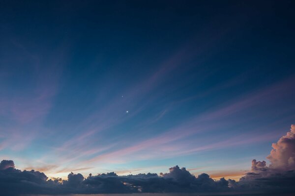 Night sky with a star and clouds