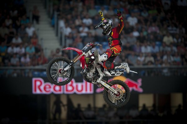 Performing a stunt in the air by a biker