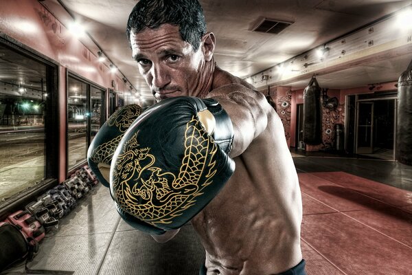 Boxer in black boxing gloves