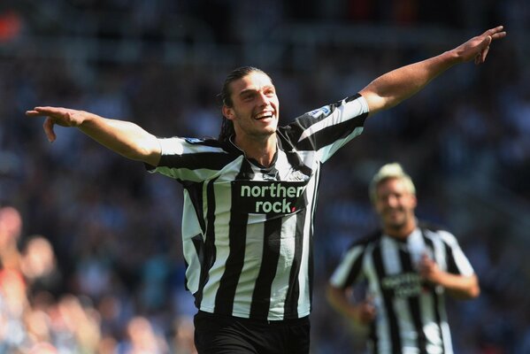 Footballer Carroll from Newcastle celebrates a goal