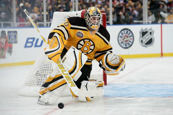 Hockey player with a puck at the gate on the ice