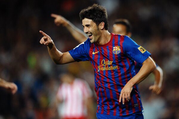 Soccer star David Villa celebrates scoring a goal during the Barcelona-Atletico match