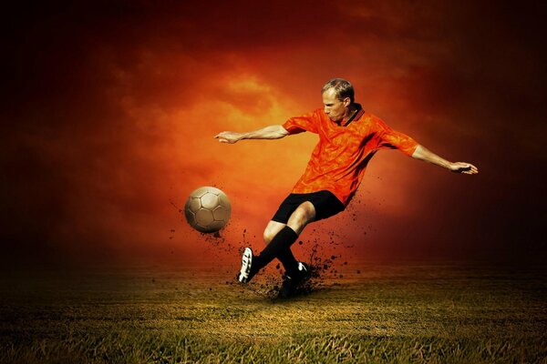 A football player in a red T-shirt hits a golden ball