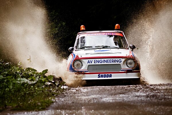 A car surrounded by splashes from the wheels