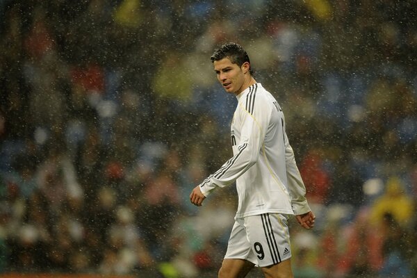 Athlete Cristiano Ronaldo on the background of rain