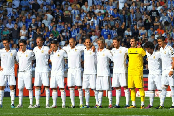 The Real Madrid team is photographed on the field against the background of fans