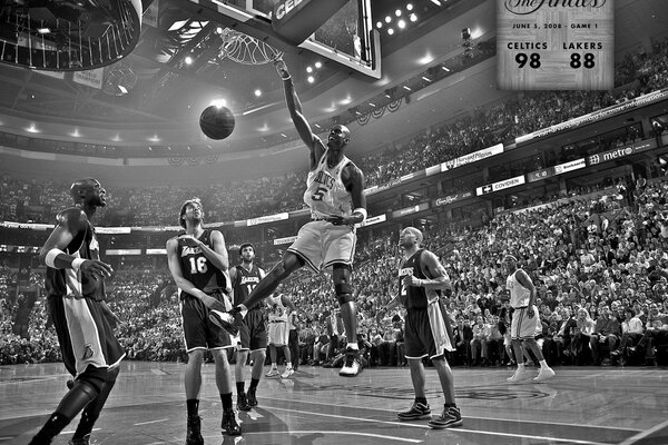 A black basketball player in a white uniform sends the ball into the ring of rivals