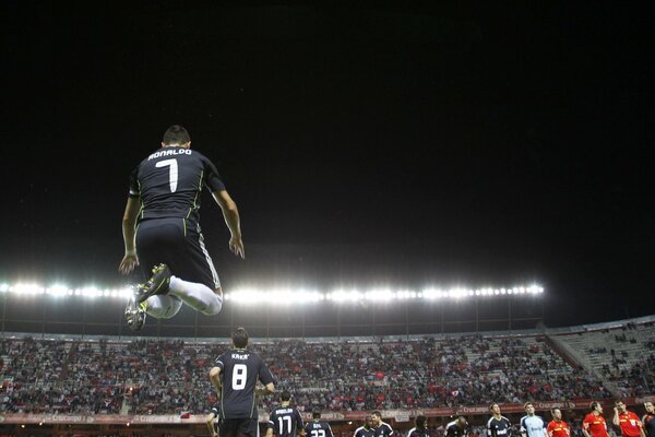 Football player in a jump over the stadium