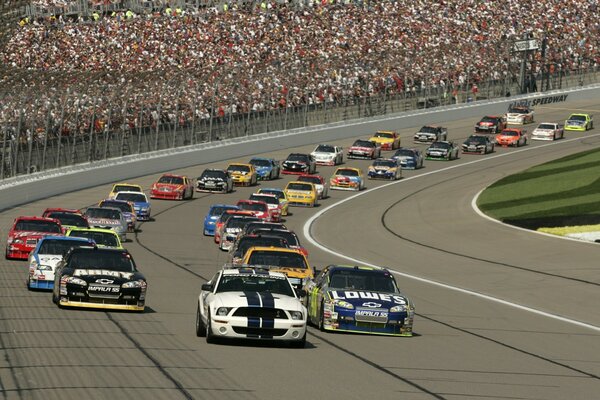 A race track with a crowd of cars