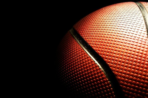 Surface texturée d un ballon de basket dans l obscurité