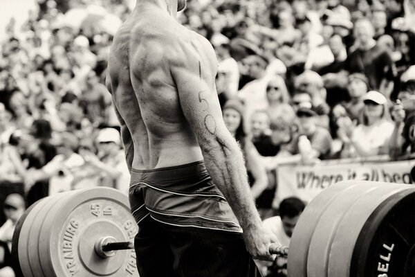 Strong man with barbell b/w