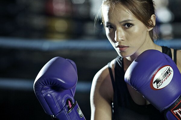Boxer girl in blue boxing gloves